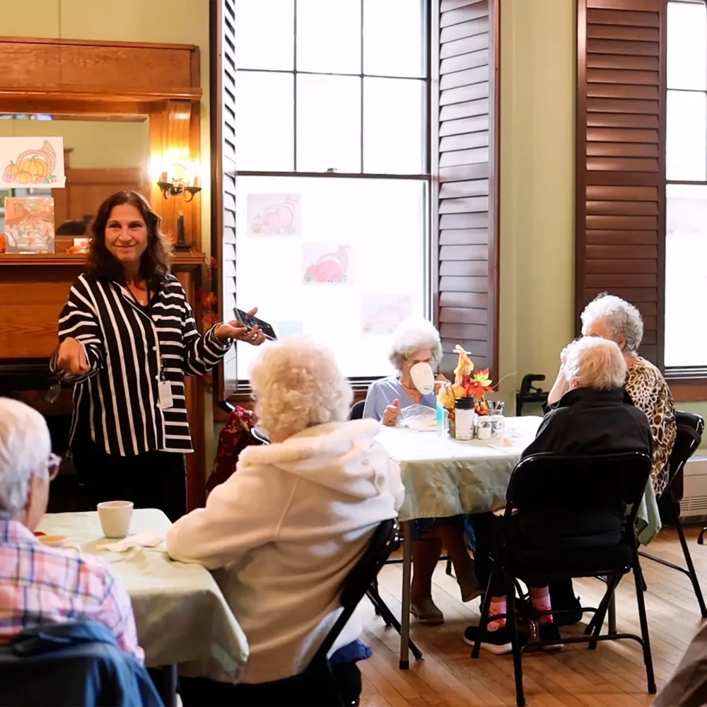 A room of seniors listening intently to a presenter